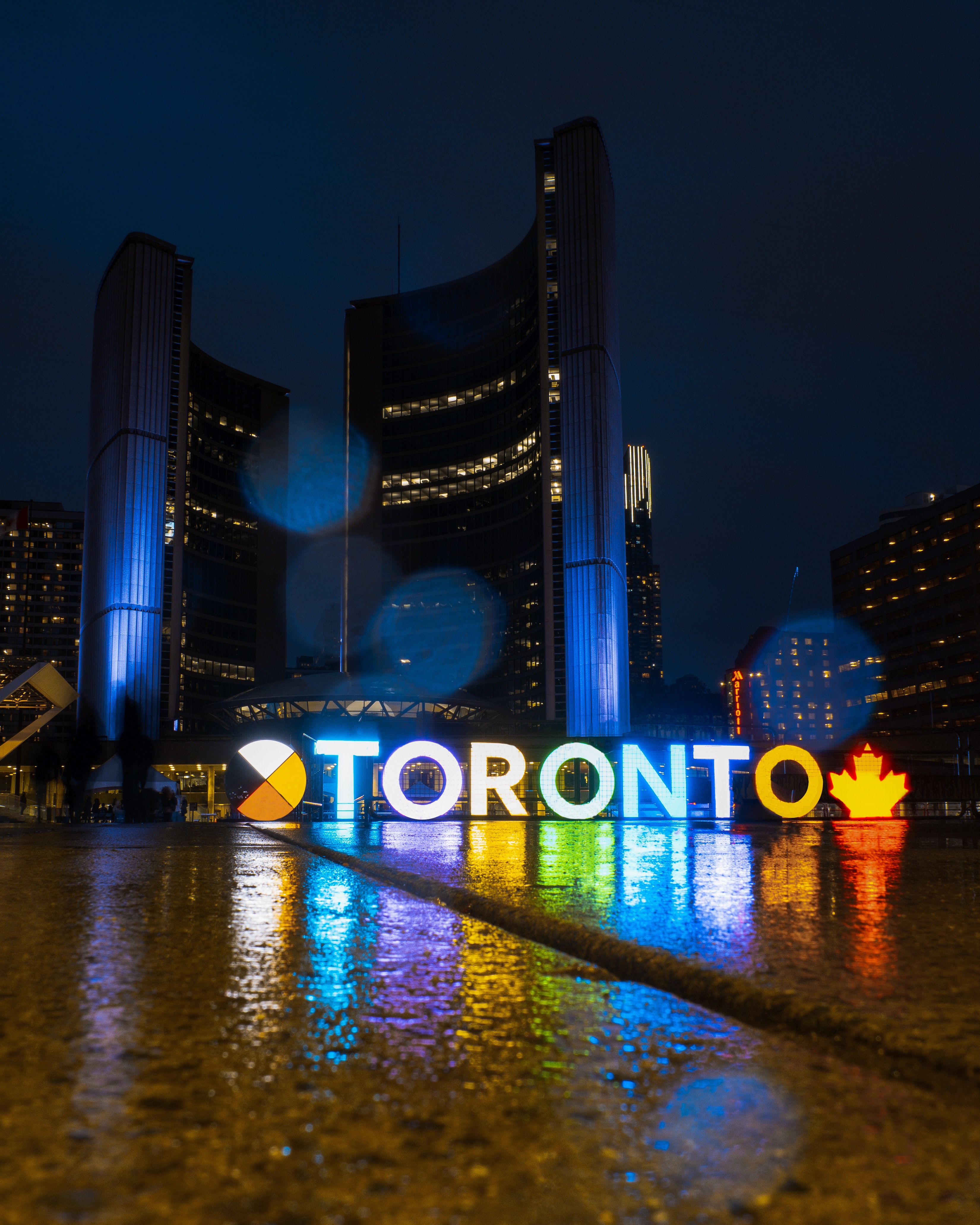 Neon sign of the word Toronto glowing at night